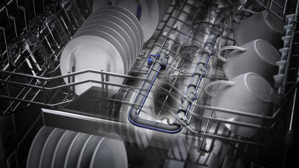Dishwasher with stacked plates and cups inside