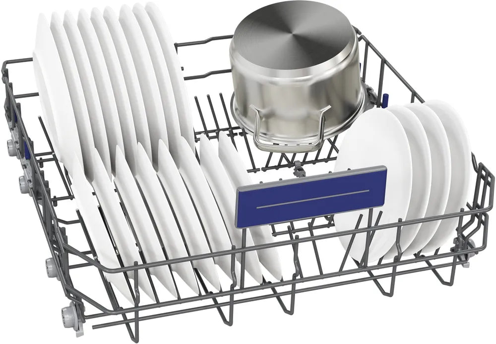 Dishwasher rack with white plates and a silver pot on a white background