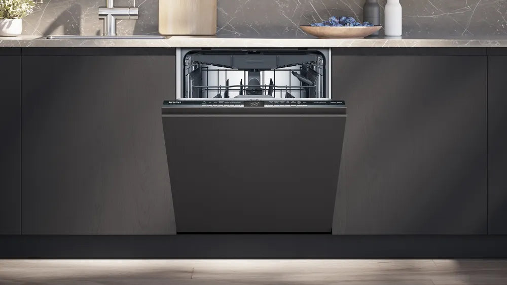Black dishwasher integrated into a modern kitchen with gray cabinets and a countertop.