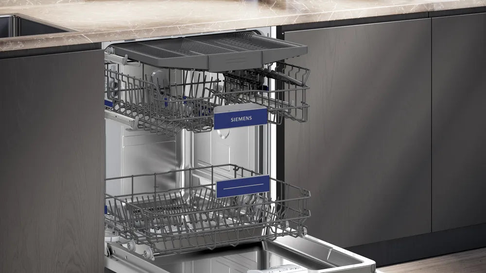 Open dishwasher with visible Siemens branding in a kitchen setting