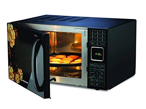 Morphy Richards 27CGF microwave oven with door open showing a tray of baked snacks inside the stainless steel cavity