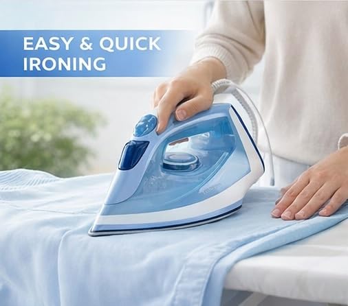 Person ironing a blue shirt on an ironing board with the Philips DST1510/20 steam iron
