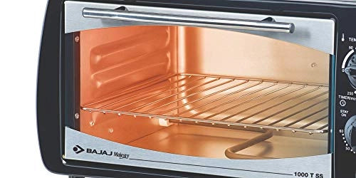 Close-up of the Bajaj Majesty 1000 T SS oven chamber with wire rack and door handle