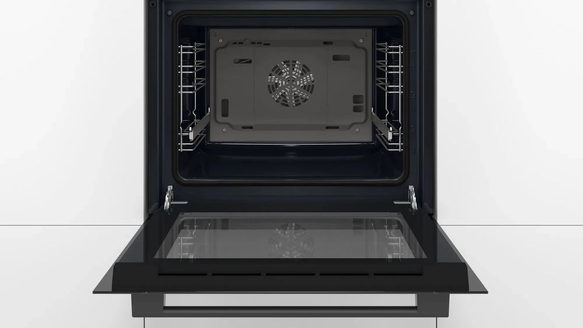 Bosch HBJ534EB0I oven with door open showing the interior, side rack runners and rear fan