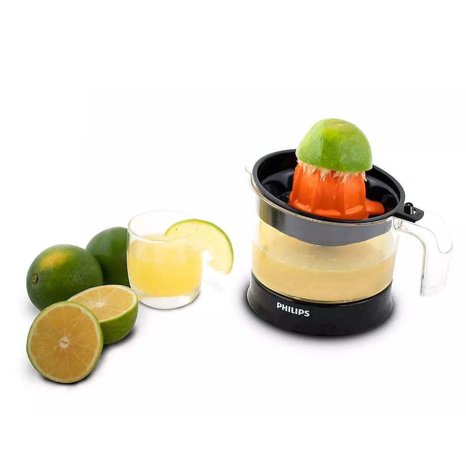 Philips HR2788/00 citrus press juicer squeezing a lime with fresh juice in the jar and a glass alongside