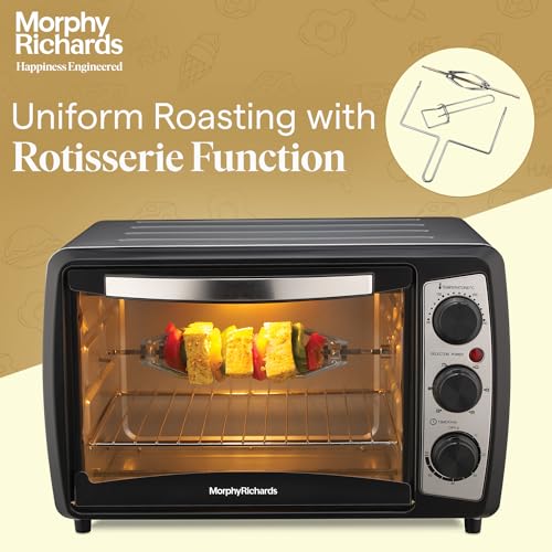 Morphy Richards 20R OTG oven roasting skewers on the rotisserie, with the rotisserie accessories shown