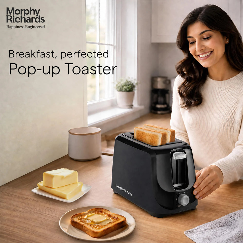 Morphy Richards AT 200 toaster on a kitchen counter with two toasted slices popped up and buttered toast on a plate
