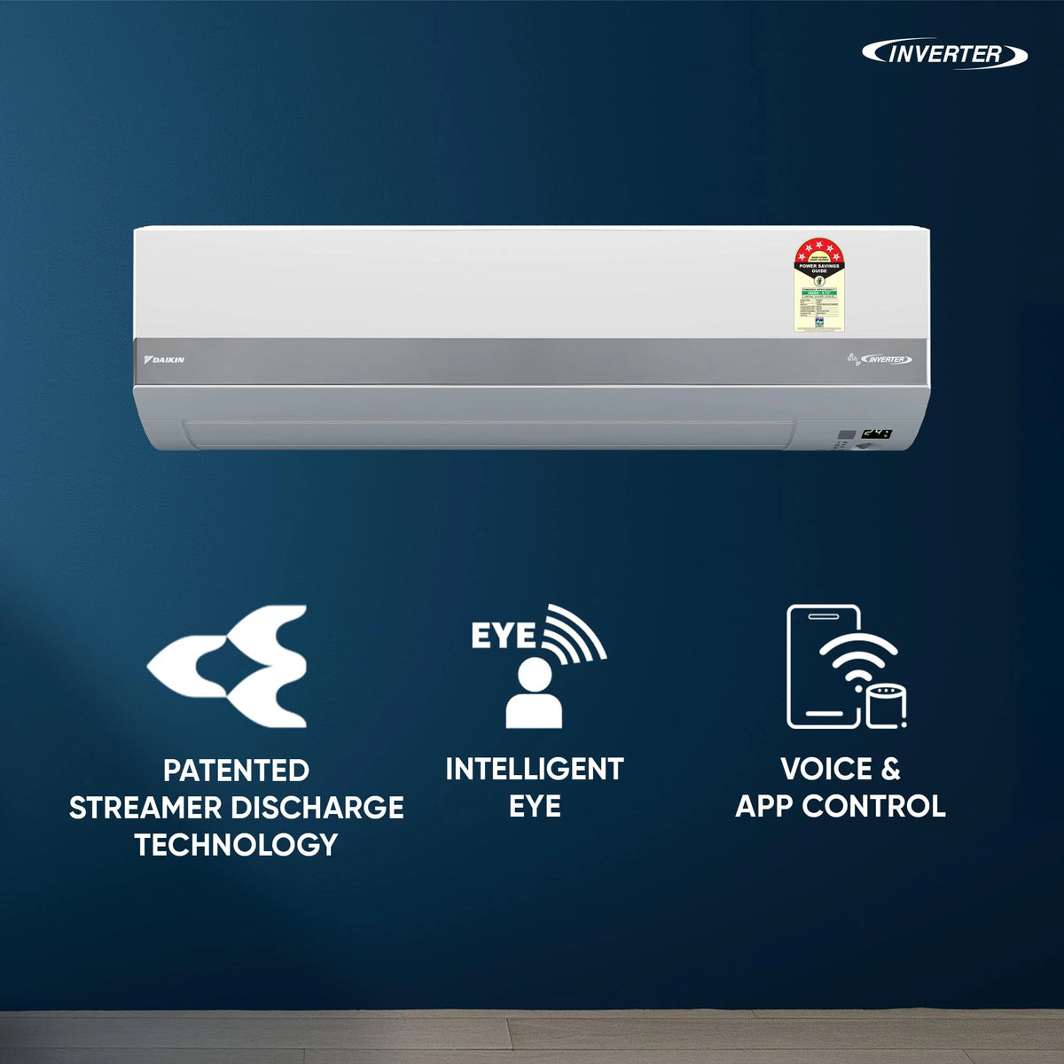 Daikin JTKJ53XV16 split AC on a blue wall with Streamer Discharge, Intelligent Eye and voice and app control icons