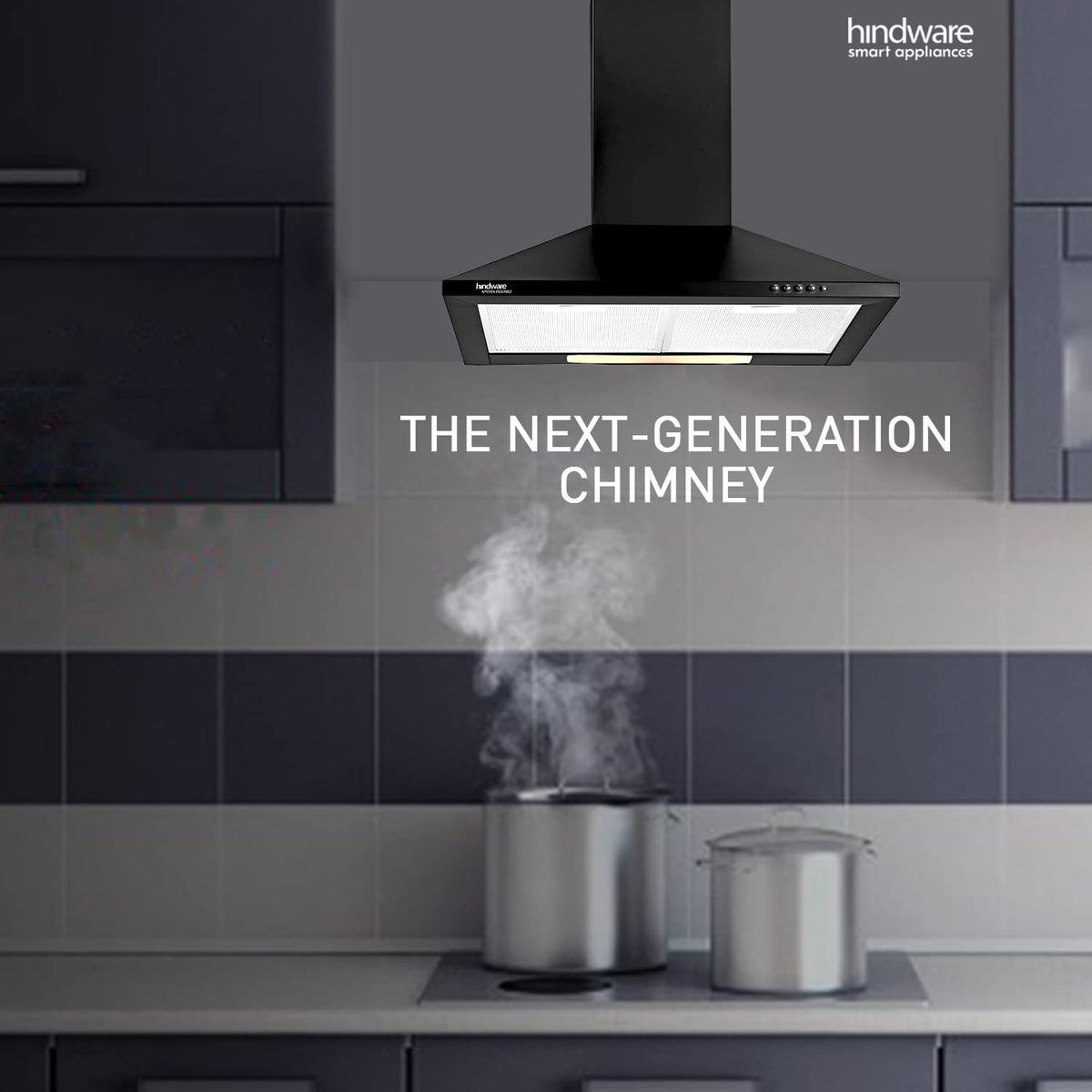 Hindware C100351 black chimney mounted above a hob with steaming pots in a modern kitchen