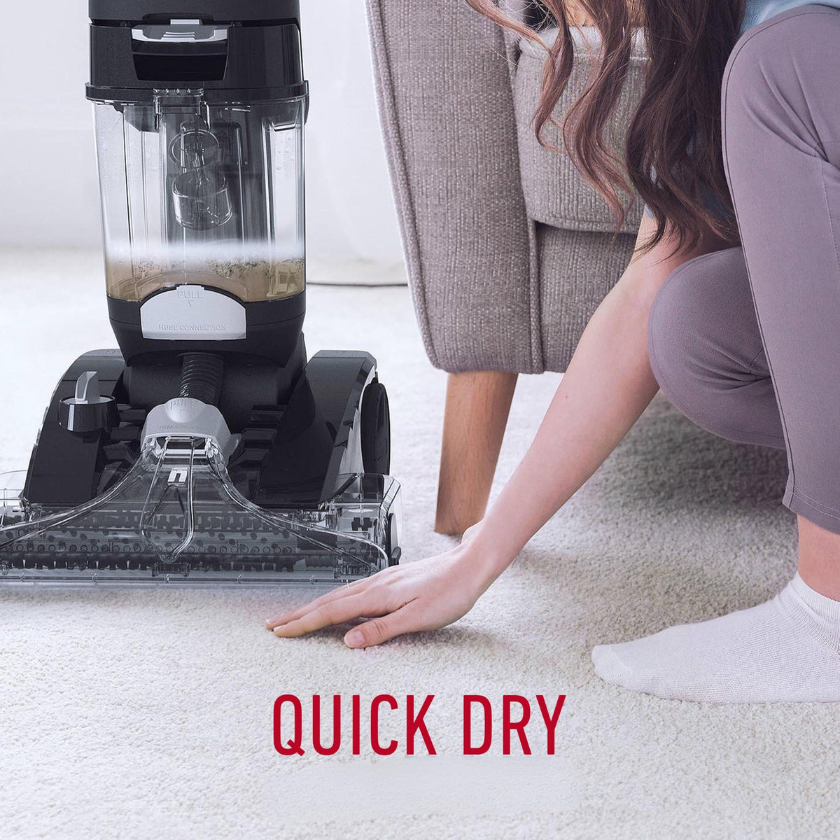 Hoover CWKTH012 Platinum Power Max on carpet with a hand checking the quick dry result and dirty water in the tank