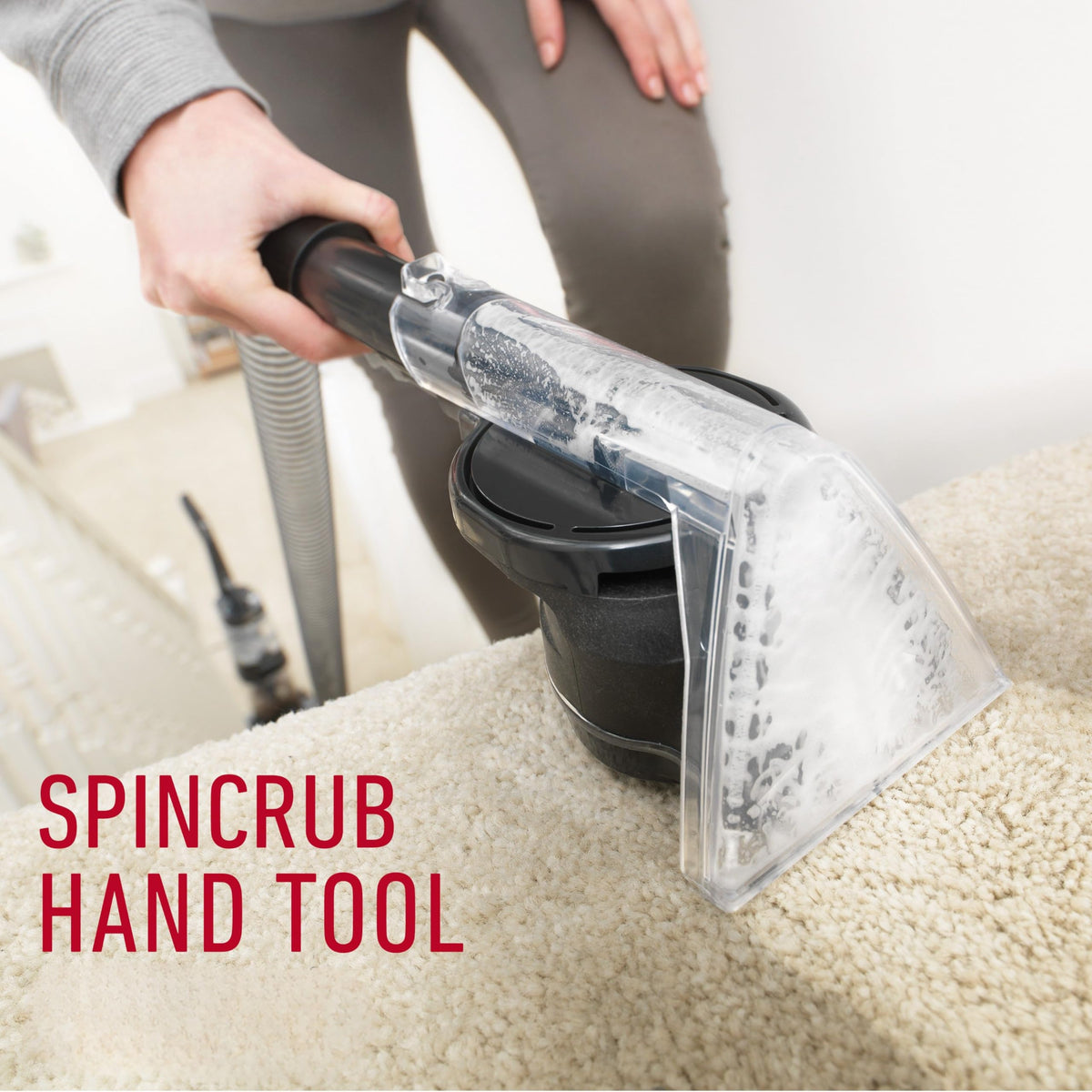 Hoover CWKTH012 SpinScrub hand tool cleaning a cream carpeted stair with foam