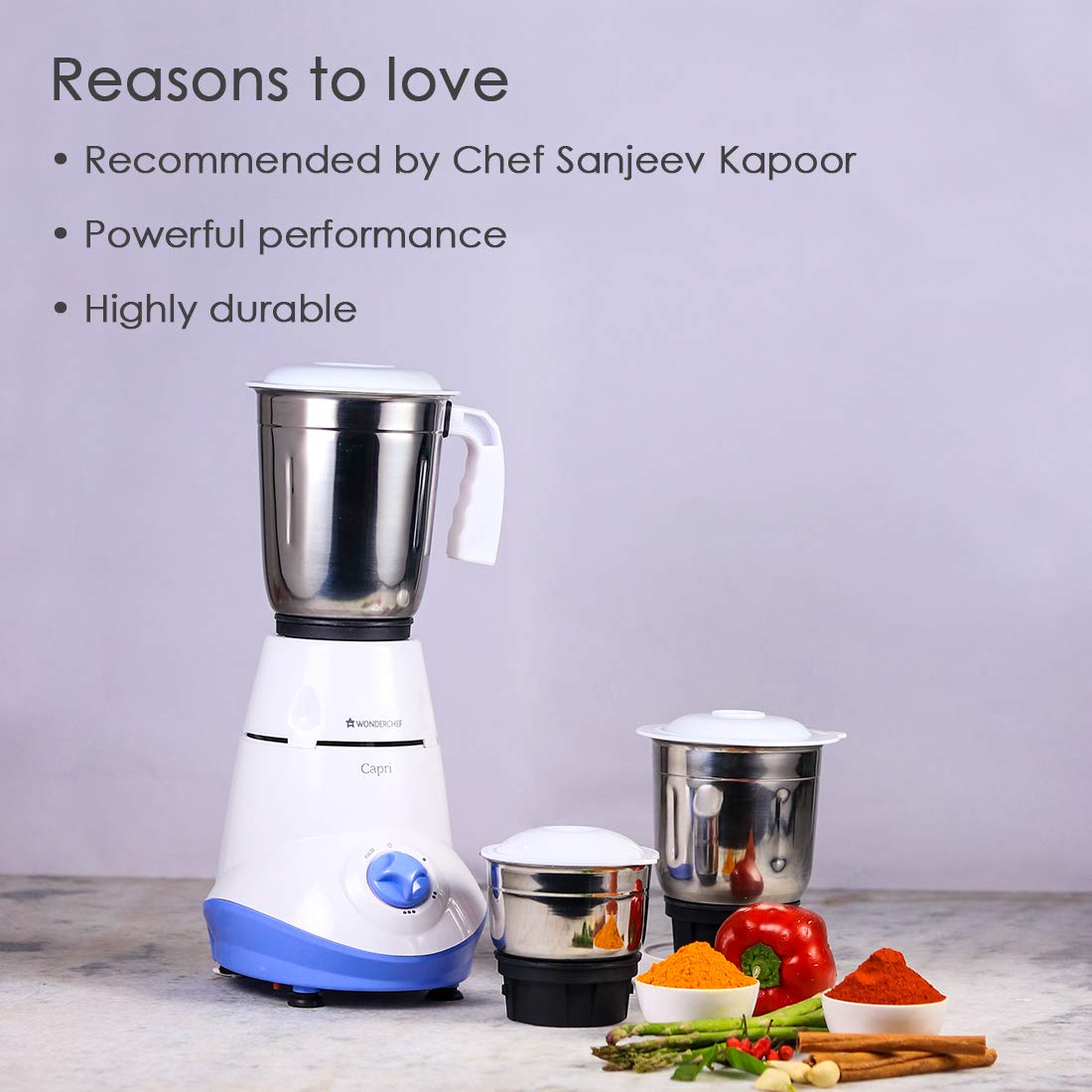 Wonderchef Capri 63153025 mixer grinder with three jars placed beside spices and vegetables