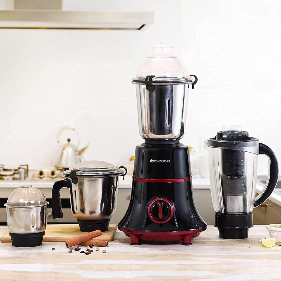 Wonderchef Glory 63153728 mixer grinder with all four jars on a kitchen counter beside whole spices