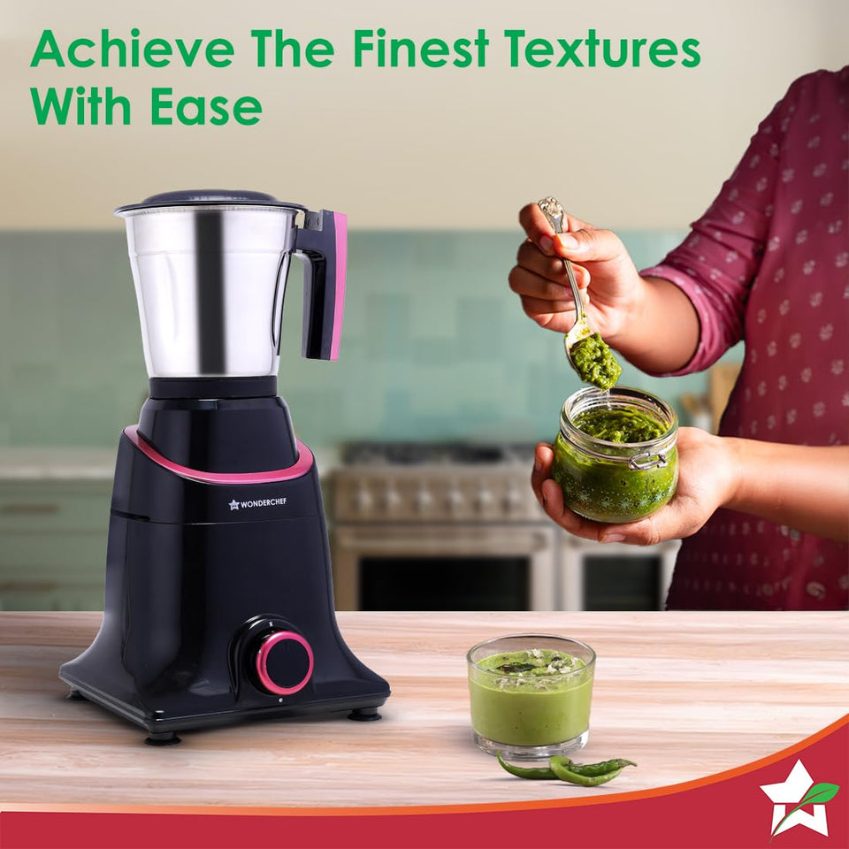 Wonderchef Select 63154957 mixer grinder with steel jar beside a jar of green chutney being spooned out