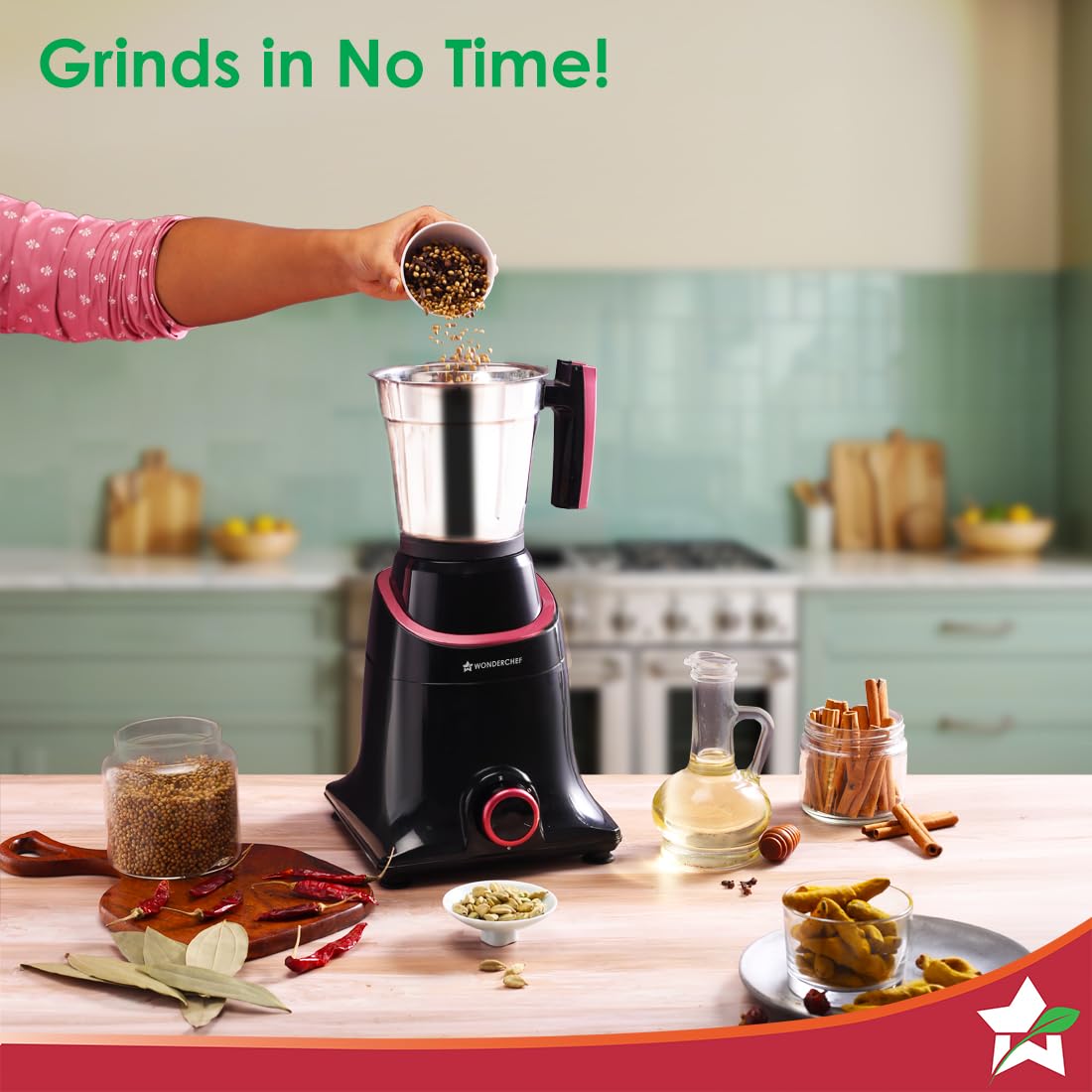 Wonderchef Select 63154957 mixer grinder with coriander seeds being poured into the steel jar, surrounded by whole spices