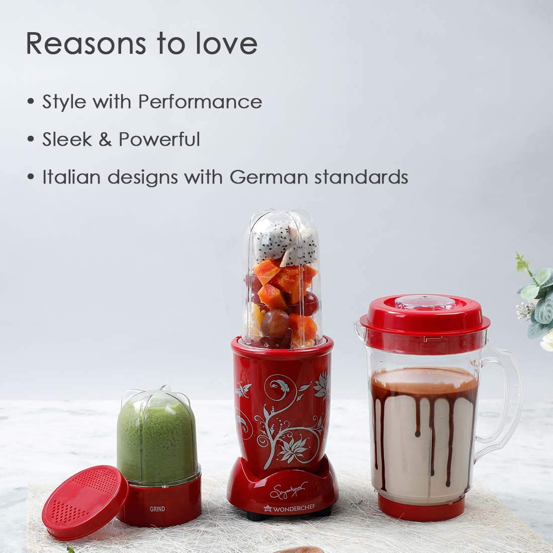 Wonderchef Nutri-blend 63152296 red mixer grinder with all three jars holding fruit, green chutney and a chocolate shake