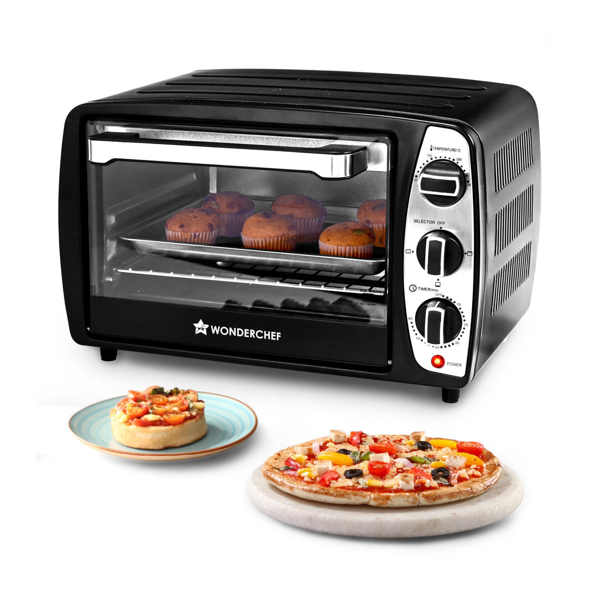 Wonderchef 63155025 17 L black OTG oven with muffins on a tray, with mini pizza and a pizza on a marble board in front