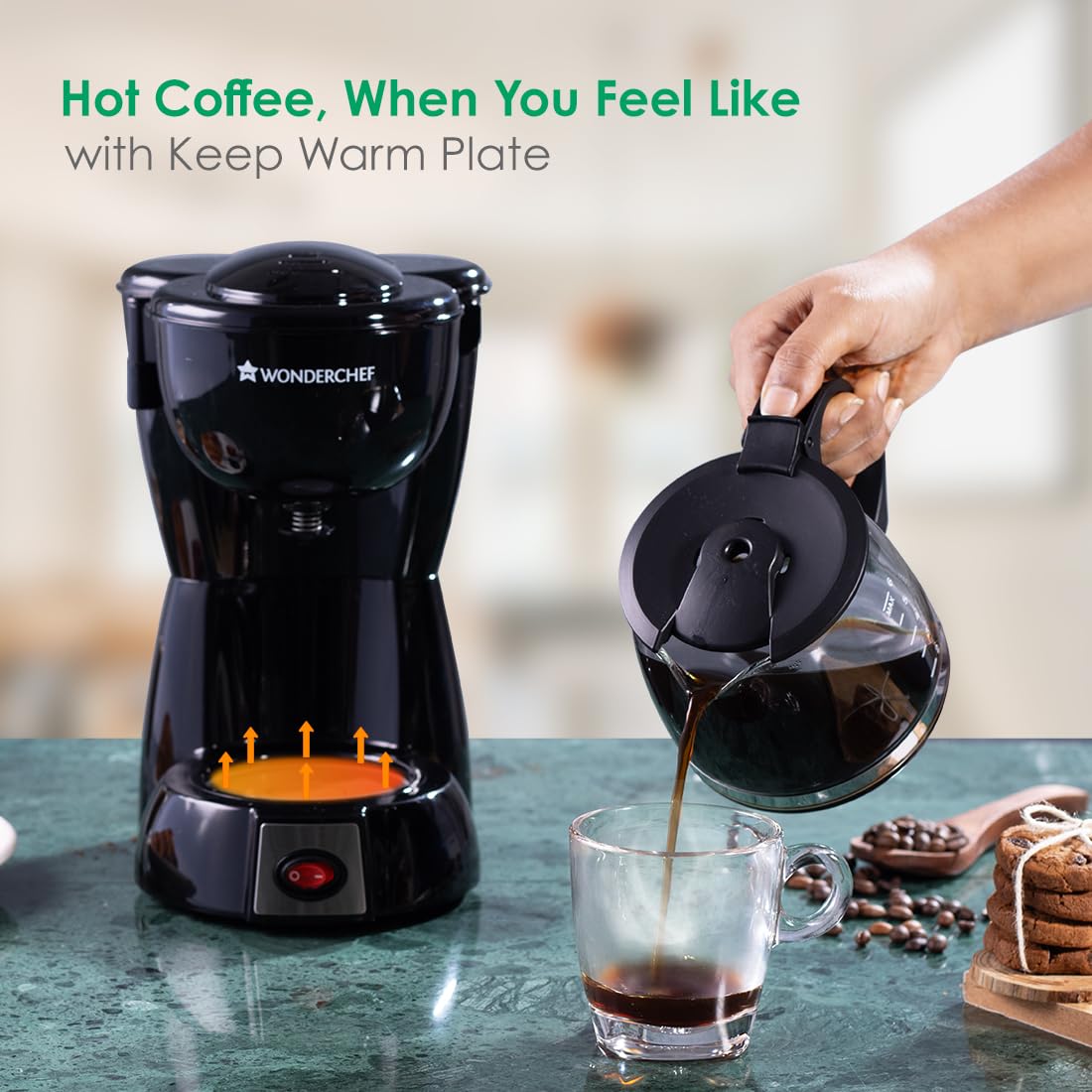Wonderchef Onyx Brew 63154852 keep warm plate highlighted while coffee is poured from the carafe into a glass cup