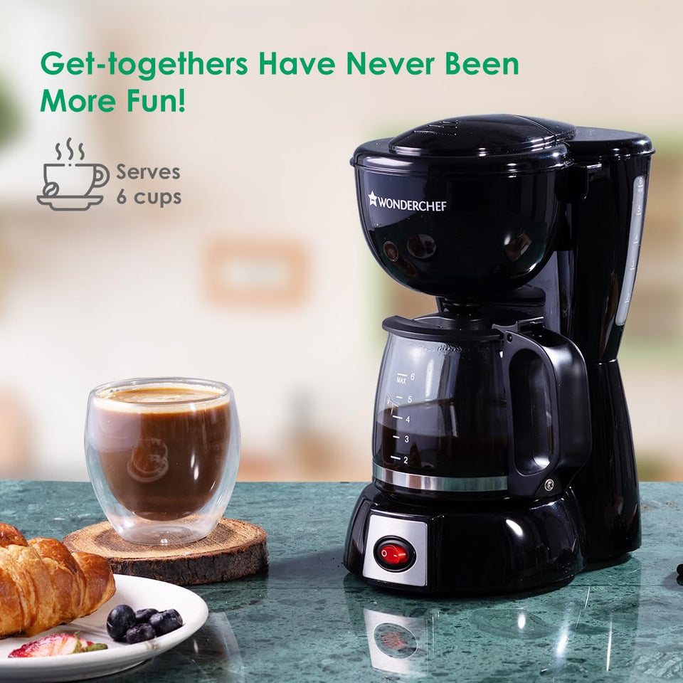 Wonderchef Onyx Brew 63154852 coffee maker beside a glass of coffee and croissant, with the Serves 6 cups label