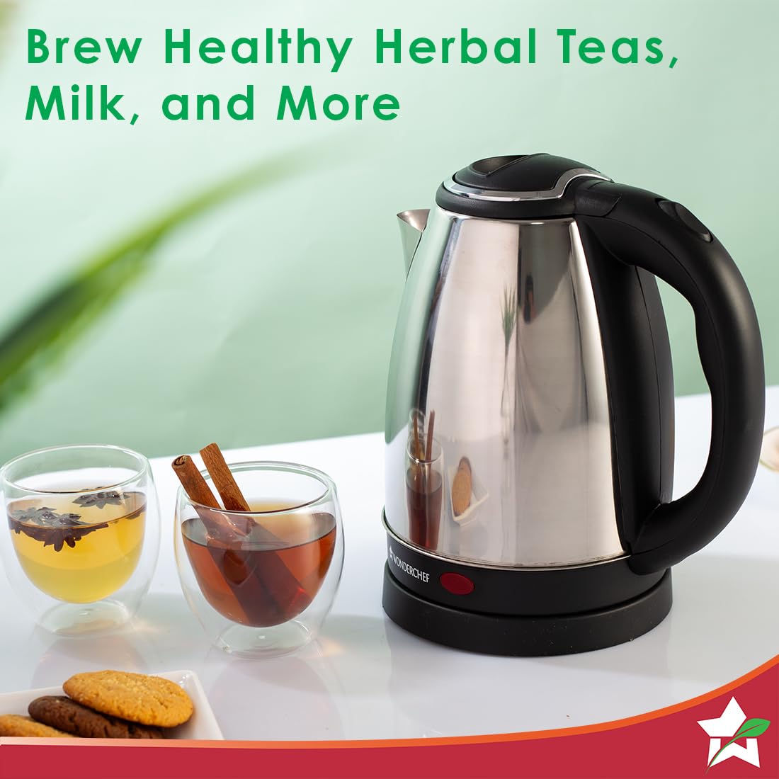 Wonderchef Crescent electric kettle beside glasses of herbal tea with cinnamon and biscuits