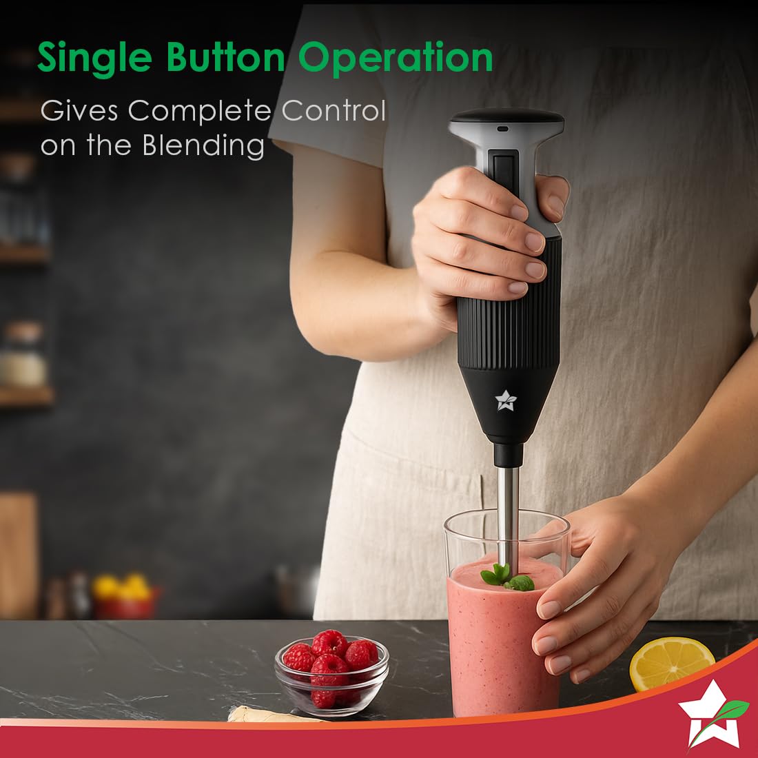 Person blending a strawberry smoothie in a glass with the Wonderchef Prima Plus hand blender