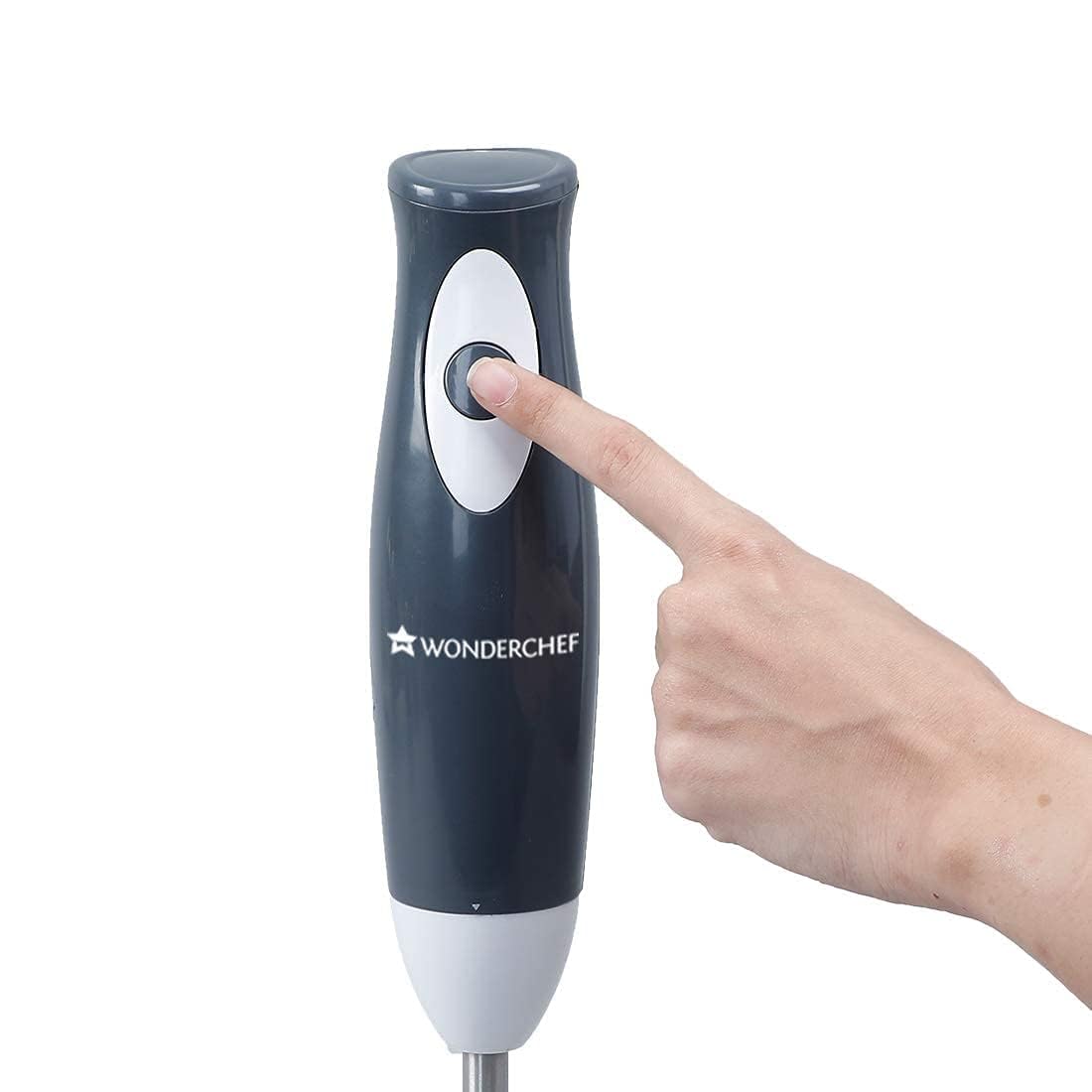 Close-up of a finger pressing the push button on the Wonderchef Ultima Plus hand blender