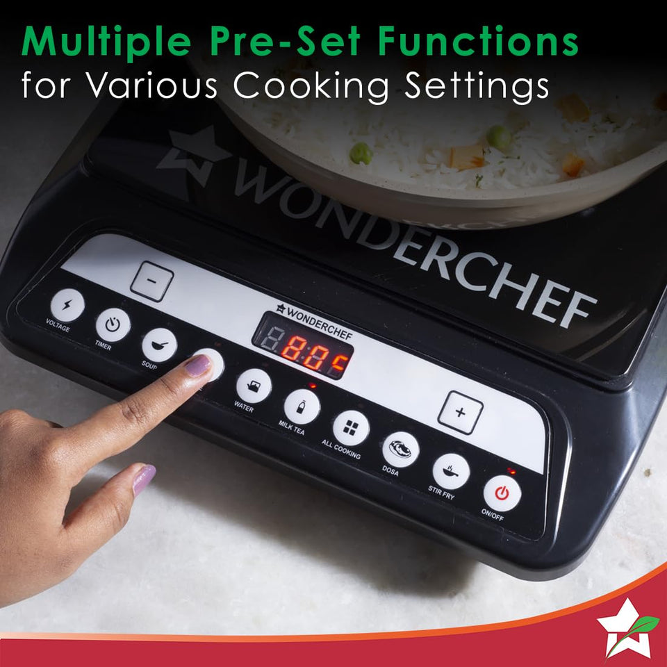 Finger pressing a preset button on the Wonderchef Power 63154814 induction cooktop with a pan of rice on top