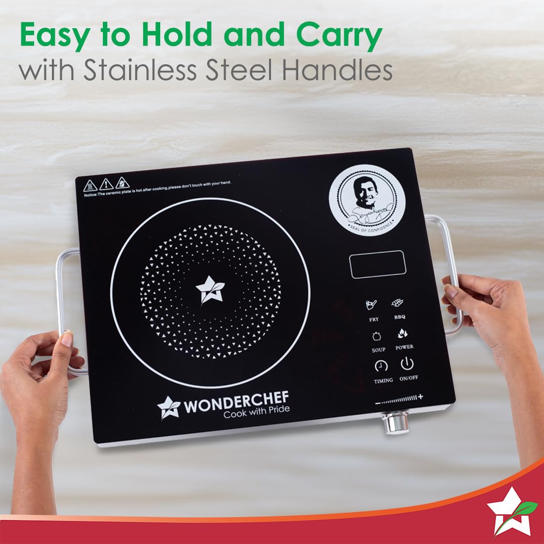 Hands holding the stainless steel side handles of the Wonderchef 63154925 infrared cooktop, showing the touch controls