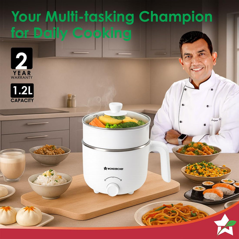 Wonderchef 63154900 Luxe multi cook kettle on a kitchen counter surrounded by cooked dishes, with 2-year warranty and 1.2 L capacity badges