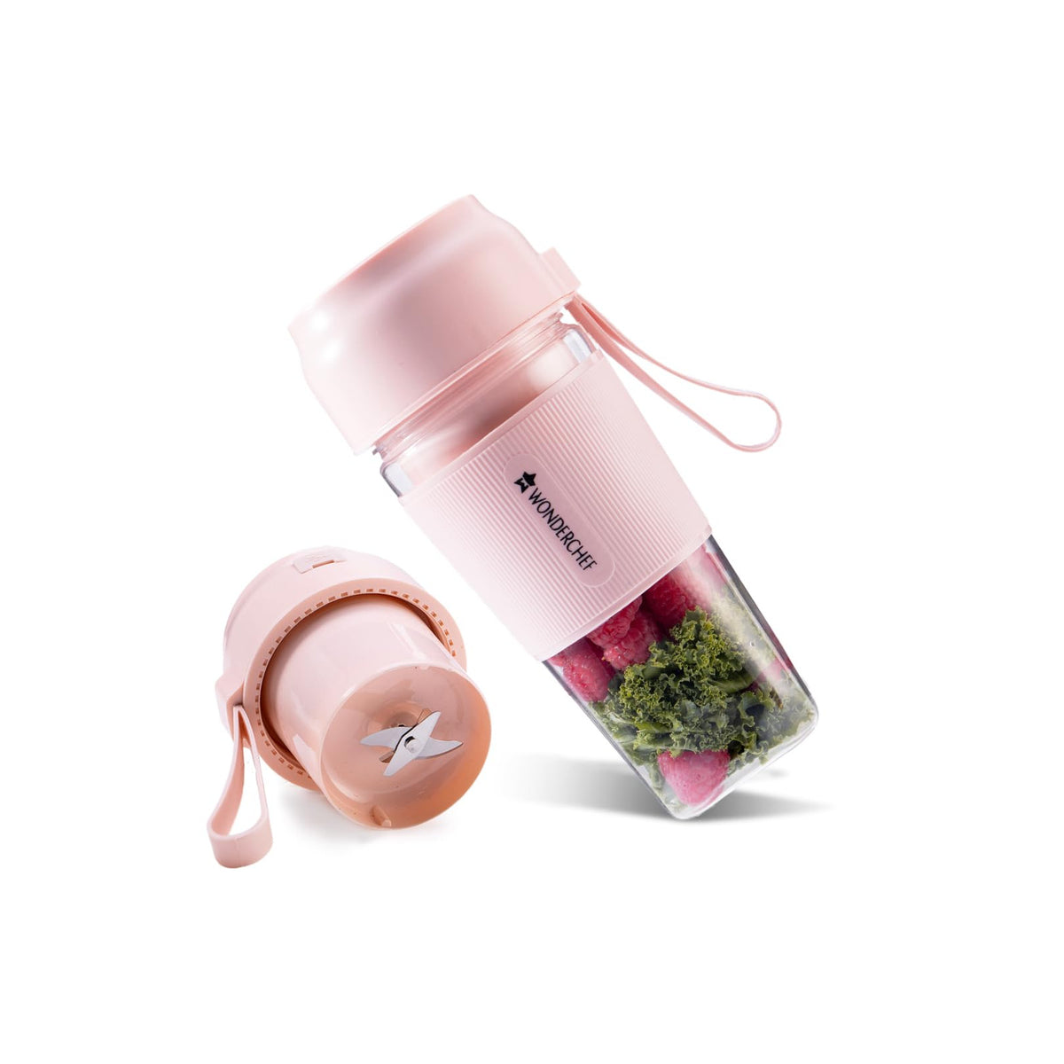 Wonderchef Nutri Cup 63154460 pink portable blender with raspberries and kale in the jar, next to the blade base with SS blade