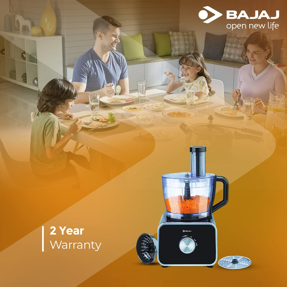 Bajaj FX-1000 Dlx food processor with a 2 Year Warranty callout above a family eating at a dining table