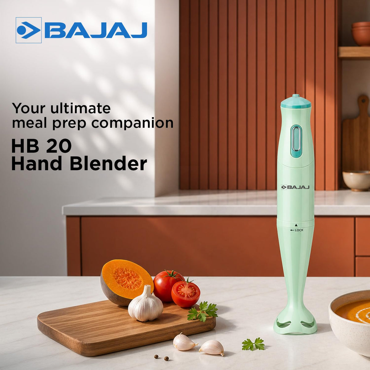 Bajaj HB 20 hand blender standing on a kitchen counter beside pumpkin, tomatoes, garlic and a bowl of soup