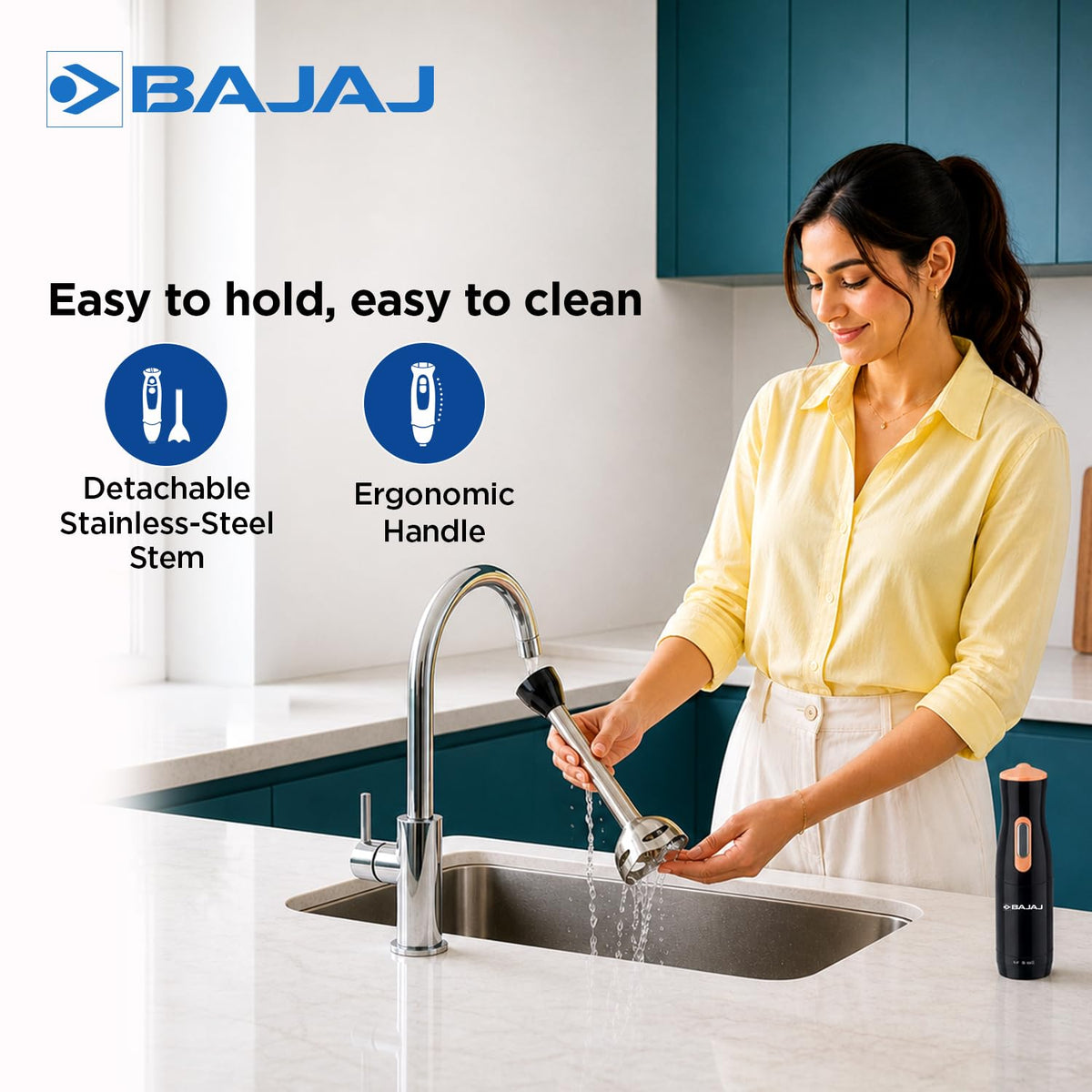 Woman rinsing the detached stem of the Bajaj HB 21 hand blender under a tap, with the motor unit beside the sink