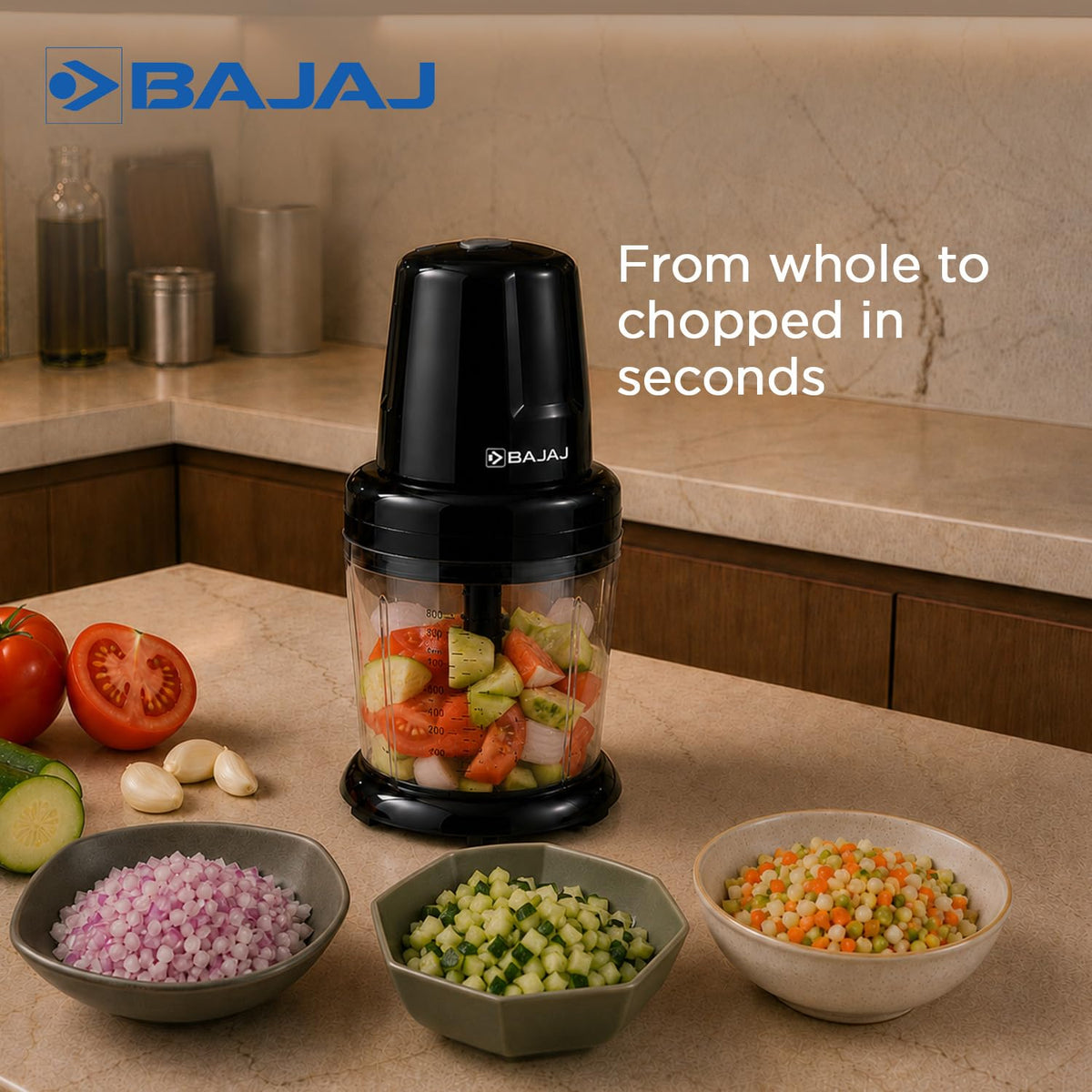 Bajaj Chop Pro chopper bowl filled with tomato, cucumber and onion pieces, with bowls of finely chopped vegetables in front
