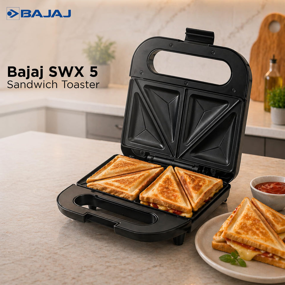 Bajaj SWX 5 sandwich toaster open on a kitchen counter with four toasted triangle sandwiches and a plate of sandwiches