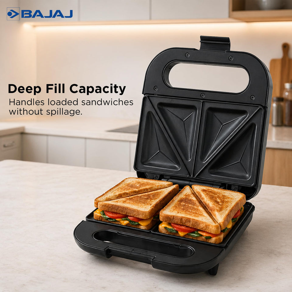 Bajaj SWX 5 sandwich toaster open showing two loaded, toasted sandwiches filled with tomato, cheese and greens