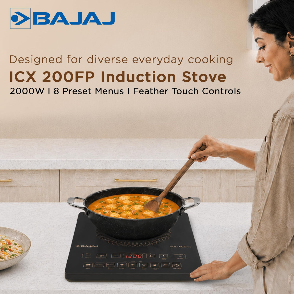 Bajaj ICX 200FP induction cooktop with a kadai of curry being stirred on a kitchen counter, 2000 W and 8 preset menus