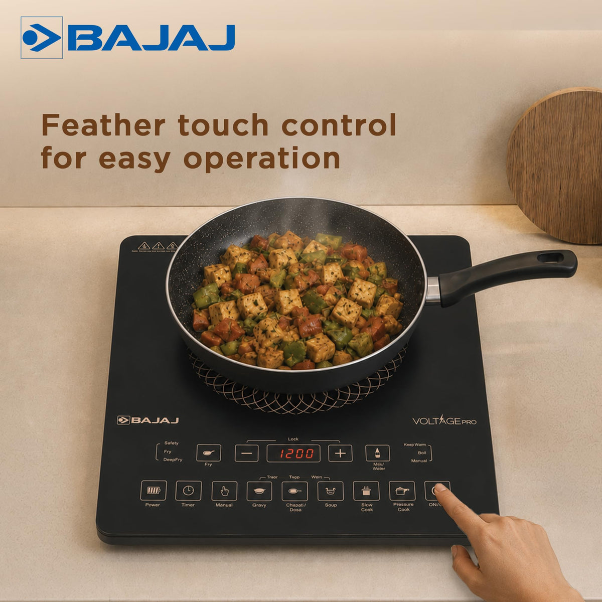 Finger touching the ON/OFF key of the Bajaj ICX 200FP induction cooktop with a pan of stir-fry, feather touch control