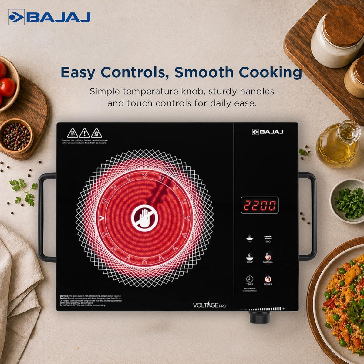 Bajaj IRX 220F Voltage Pro cooktop seen from above with its glowing red heating zone, 2200 display, preset touch buttons and temperature knob
