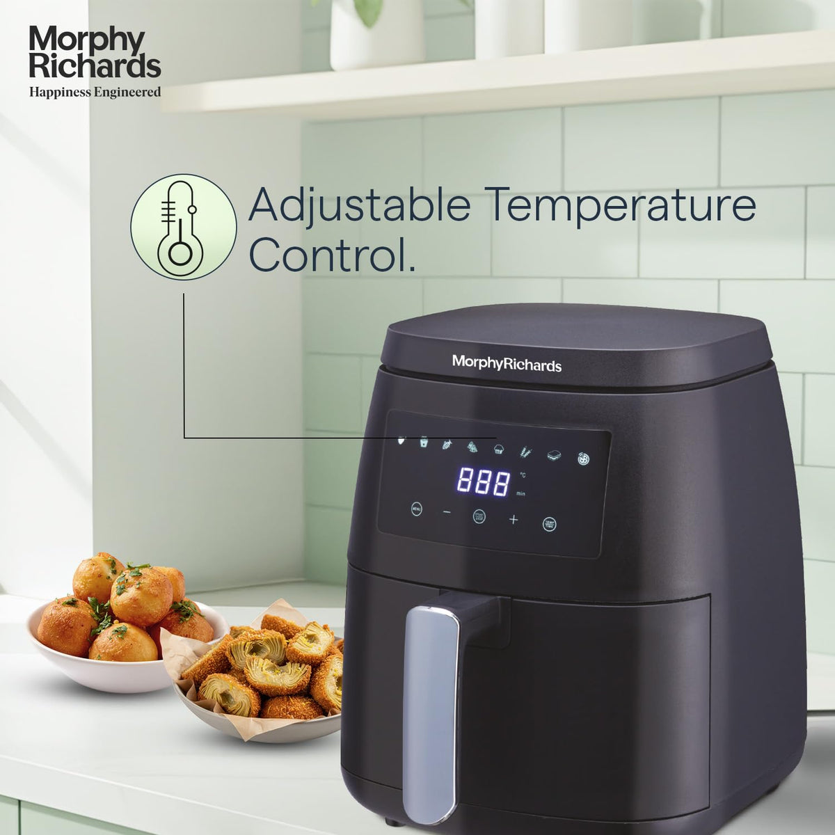 Morphy Richards 510056 air fryer with digital display and adjustable temperature control, beside bowls of snacks