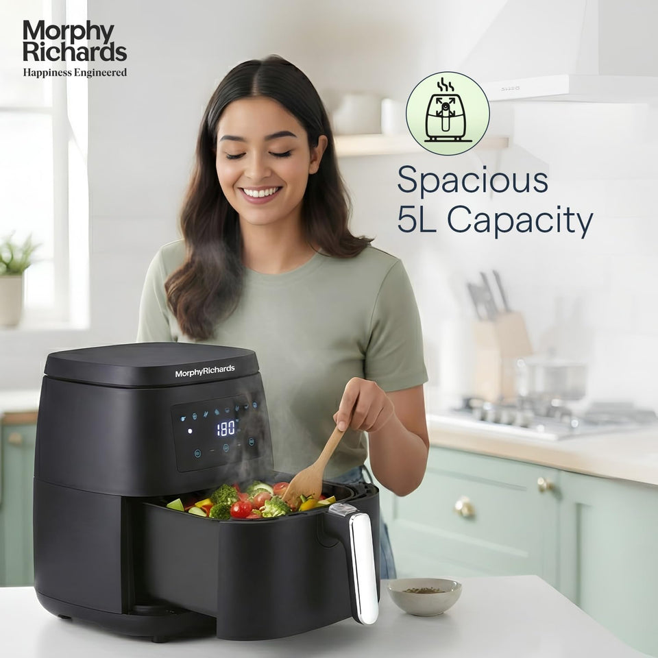 Morphy Richards 510056 air fryer with basket pulled out showing cooked vegetables, highlighting 5 L capacity