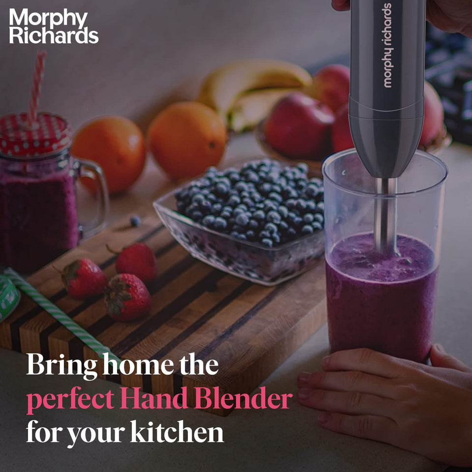 Morphy Richards Pronto Plus hand blender being used to blend a berry smoothie in a tall beaker