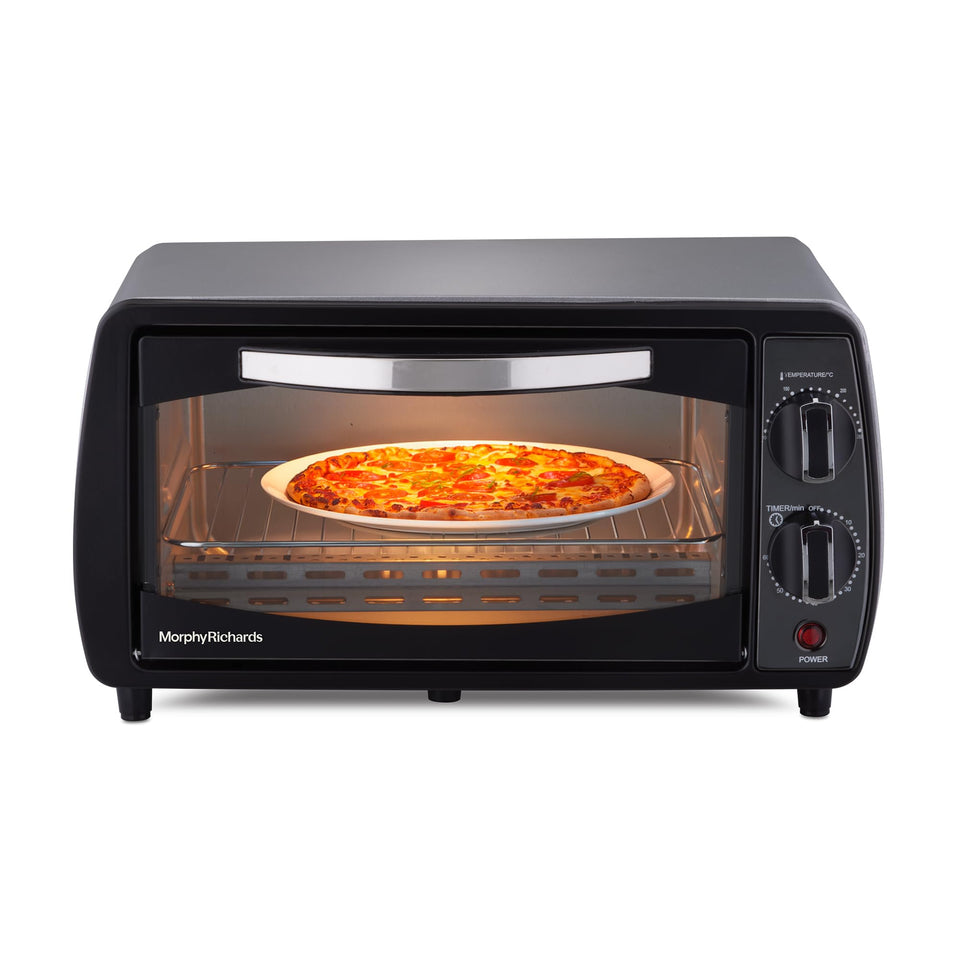 Front view of the Morphy Richards 510065 10 L OTG oven with a pizza on the wire rack and temperature and timer knobs on the right