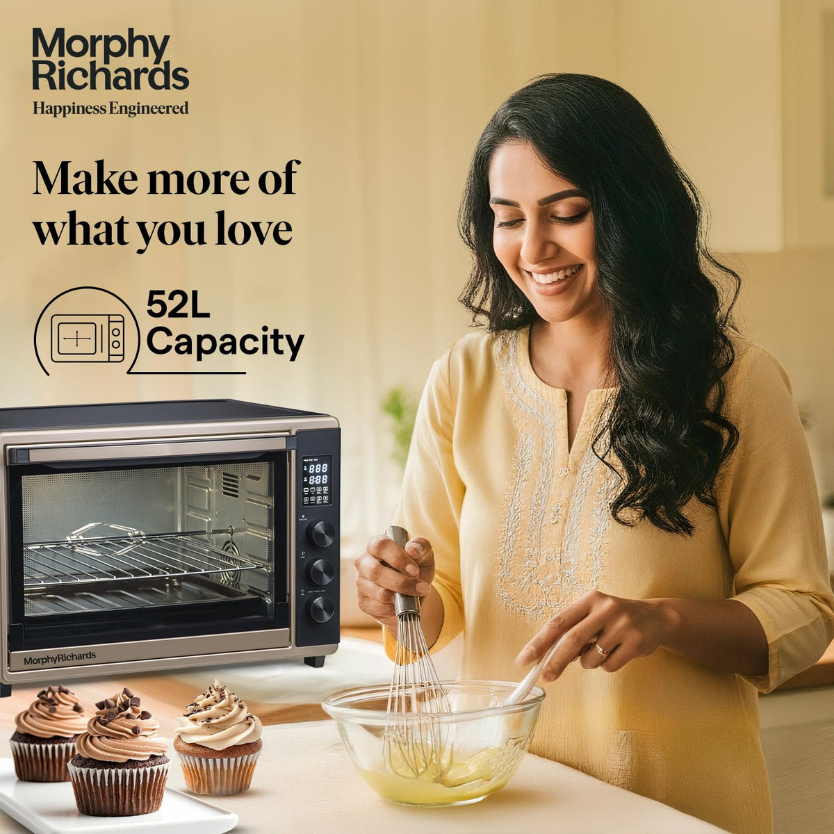 Morphy Richards 52RCD Digi 52 L OTG beside a woman whisking batter with cupcakes in the foreground