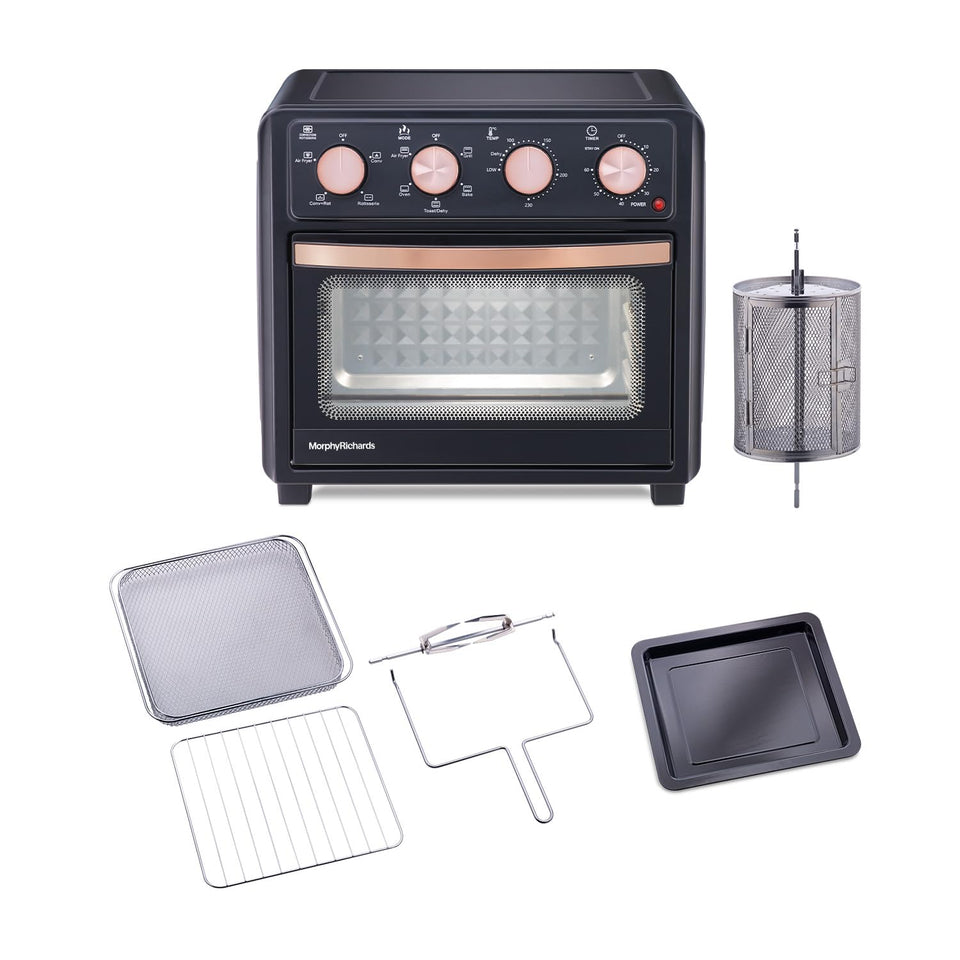 Morphy Richards 510060 AirCrisp air fryer oven with its accessories: rotisserie basket, wire basket, grill rack, rotisserie rod and baking tray