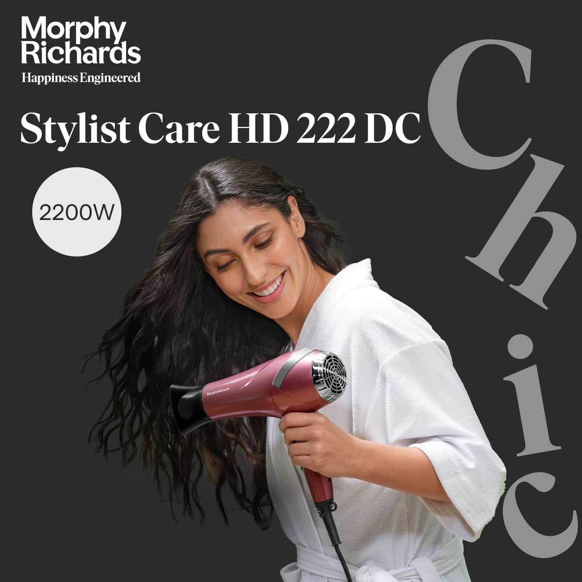 Woman in white robe styling her long wavy hair with the Morphy Richards Stylist Care HD222DC 2200W hair dryer
