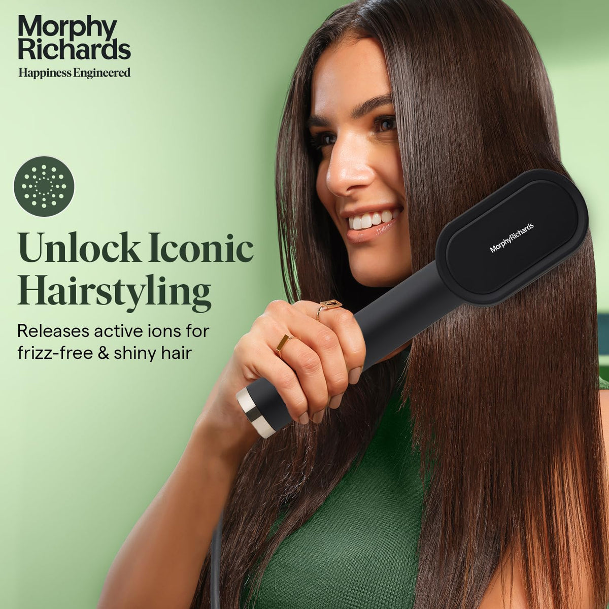 Morphy Richards Estella Hair Straightener Brush being used on long dark hair, with the ionic function highlighted