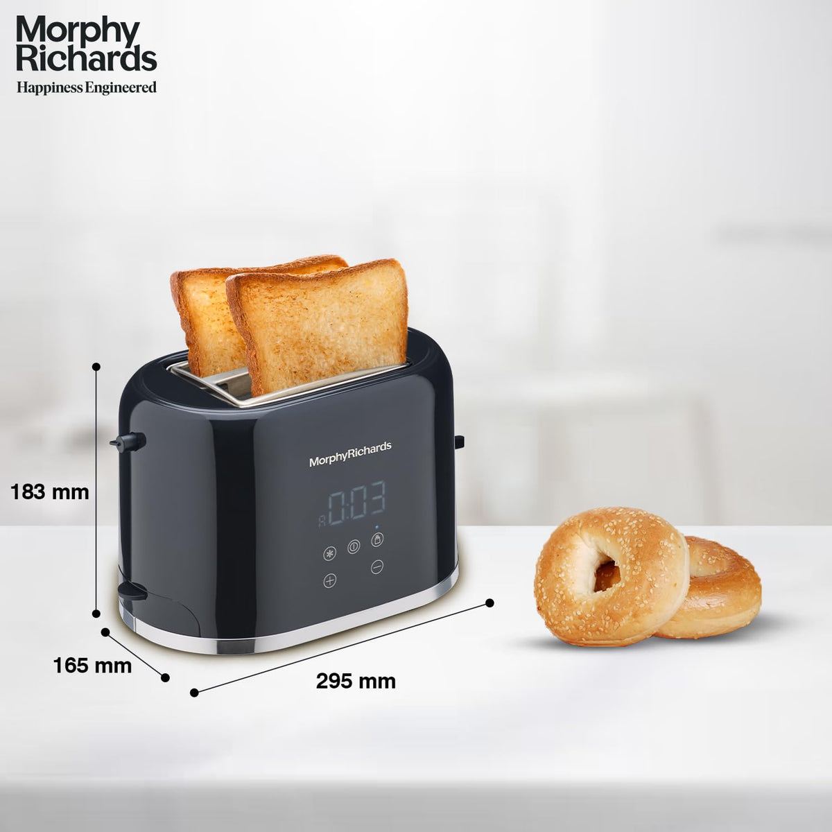 Morphy Richards 370071 toaster with dimensions marked as 183 mm height, 165 mm depth and 295 mm width, with two bagels beside it
