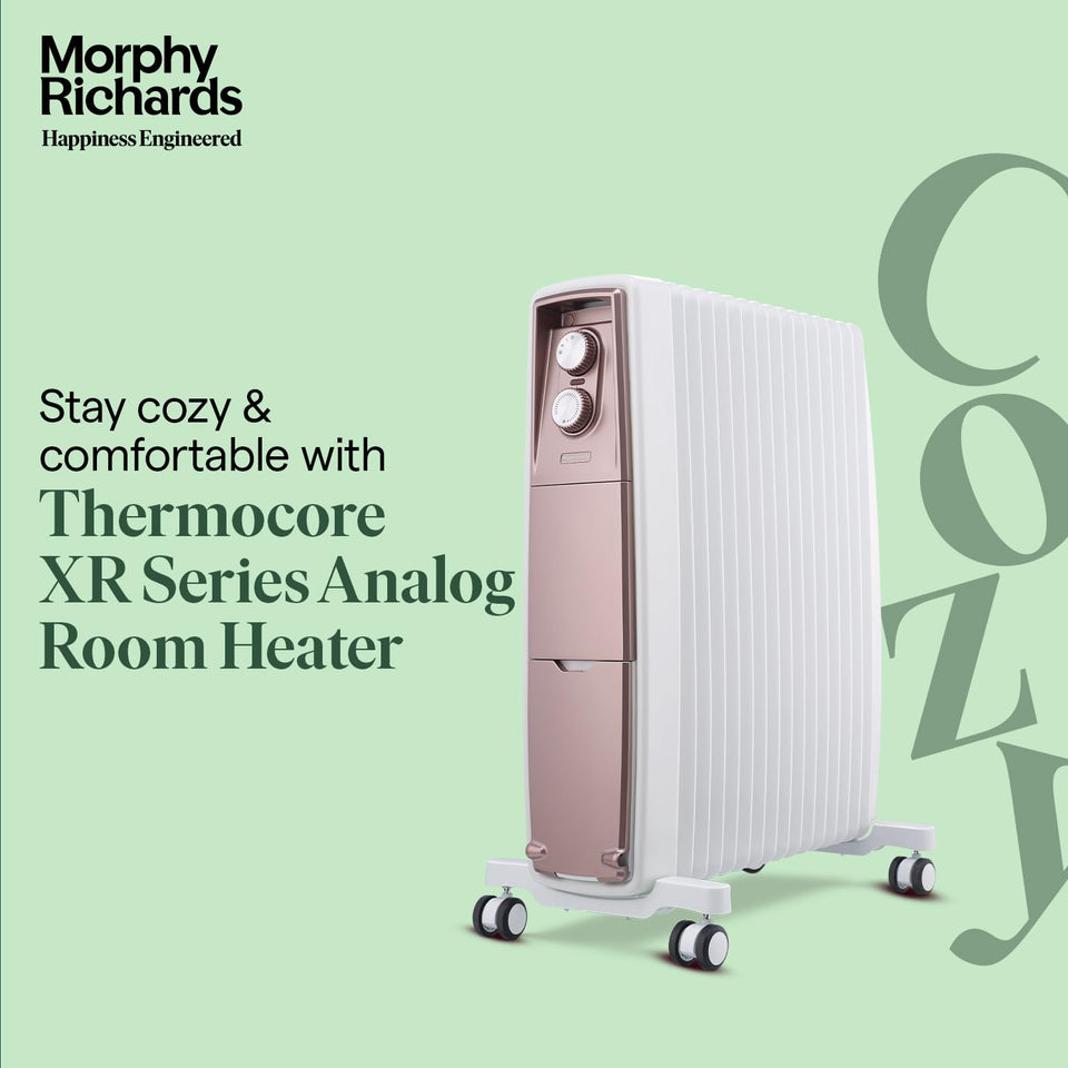 Morphy Richards 290019 Thermocore XR analog room heater with 15 white fins and rose gold control panel on a green background