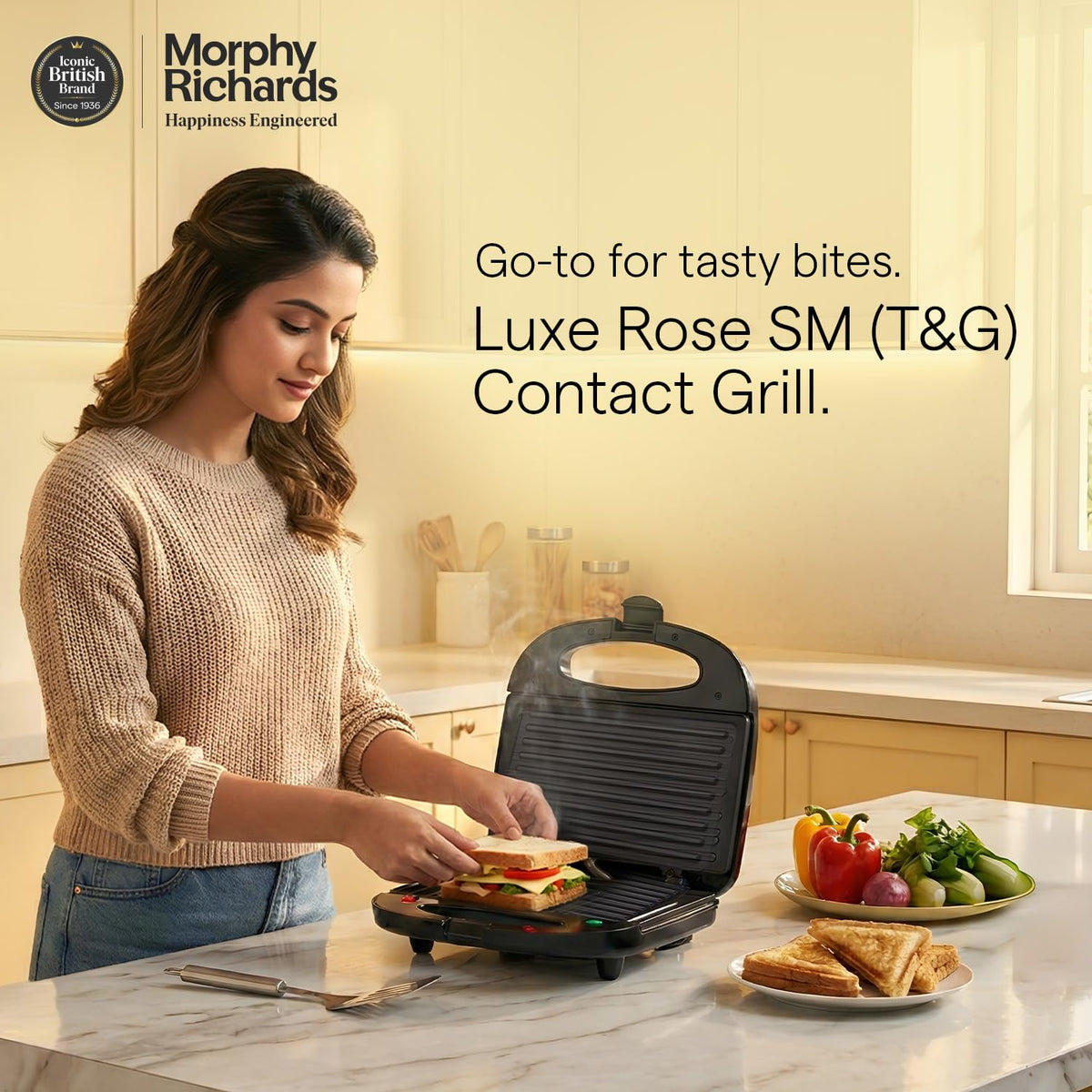 Woman placing a sandwich on the Morphy Richards Luxe Rose (T&G) contact grill in a kitchen